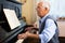 Compositor creating new music with piano at home