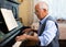 Compositor creating new music with piano at home