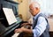 Compositor creating new music with piano at home