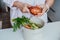 Compost the kitchen waste, recycling at home. Woman cleaning sweet potato and putting vegetables cutted leftovers into