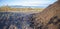 Composted olive mill pomace piled beside vineyard