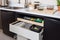 composting system built into kitchen countertop, with bins and ingredients for making compost or tea