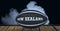 Compostion of rugby ball with text new zealand on black background with white smoke