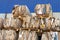 Compressed cardboard and used paper wrap collected in stacks with forklift for recycling and reiuse. Recyclable materials and