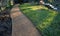 Compressing the gravel of the new park threshing path. lawn seed is repaired by rolling a metal hand roller, which is filled with