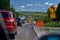 Compton, Quebec, Canada -- September 8, 2018: road sign written in french circulation avec vehicule escorte on a road in