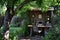 A computer desk sits on top of a sturdy wooden table, providing a functional workspace, An outdoor home workspace in the backyard