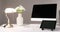 Computer, digital tablet, table lamp and flower vase