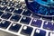 Computer keyboard close up with blue sunglasses reflection