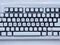 Computer keyboard covered with white snow with inscription merry christmas