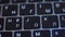 Computer keyboard details background. Action. Close up top view of white letters on black keypad buttons of a modern