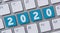 A  computer keyboard with the word 2020