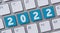 A  computer keyboard with the word 2022
