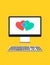 Computer monitor with two hearts depicting online dating concept