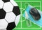 Computer mouse, sanitizer, blue medical mask, empty plate like soccer ball placed on green felt mini football field, top view.