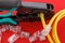 Computer network laying concept. Crimper tool and transparent connectors connectors on red background. Crimper and ethernet cable