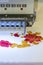 Computerized embroidery machines. sewing machine on blurred background. textile workshop. closeup. vertical photo