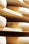 ComtÃ© cheese refining cellar on traditional spruce wooden shelves, closeup