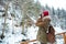 Concenrated woman photographer standing and taking pictures in mountains