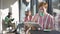 Concentrated absorbed handsome redhead man reading book drinking coffee at table in retro coffee shop with blurred