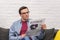 concentrated adult man reading business newspaper on couch