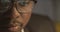 Concentrated African American businessman in eyeglasses in front of laptop with reflection of display in eyeglasses