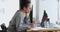 Concentrated african american female secretary in eyeglasses working in office.