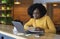 Concentrated black girl browsing job opportunities on laptop