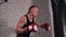 Concentrated boxer punching and kicking boxing bag at gym