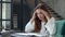 Concentrated business woman working with papers. Girl reading documents