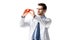 Concentrated cardiologist wearing white coat with stethoscope and holding toy heart