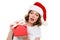 Concentrated caucasian lady wearing christmas hat holding gift