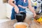 Concentrated Caucasian woman preparing breakfast in the kitchen