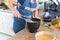 Concentrated Caucasian woman preparing breakfast in the kitchen