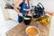 Concentrated Caucasian woman preparing breakfast in the kitchen