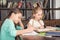 Concentrated classmates doing homework together in library