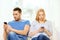 Concentrated couple with smartphones at home