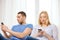 Concentrated couple with smartphones at home