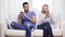 Concentrated couple with smartphones at home