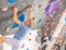 Concentrated elderly man moving on bouldering wall in climbing gym