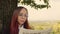 Concentrated elegant lady reading newspaper in park. Focused young female entrepreneur with long dye hair in formal wear