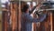 Concentrated engineer repairing large beer tank in brewery. Side view portrait of focused professional male Caucasian