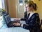 Concentrated european woman work on laptop at home