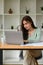 Concentrated female auditor holding magnifying glass examining the numerical data on financial document