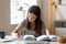 Concentrated female student handwrite studying at home