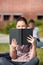 Concentrated female student reading a book outdoor