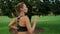 Concentrated fit woman running fast in park. Female runner training in morning