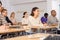 Concentrated hispanic girl at lecture during adult education class