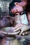 Concentrated Indian potter artist making clay pot or on traditional cart wheel - concep of handcraft work, Poverty