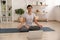 Concentrated indian woman sit in lotus pose before laptop screen